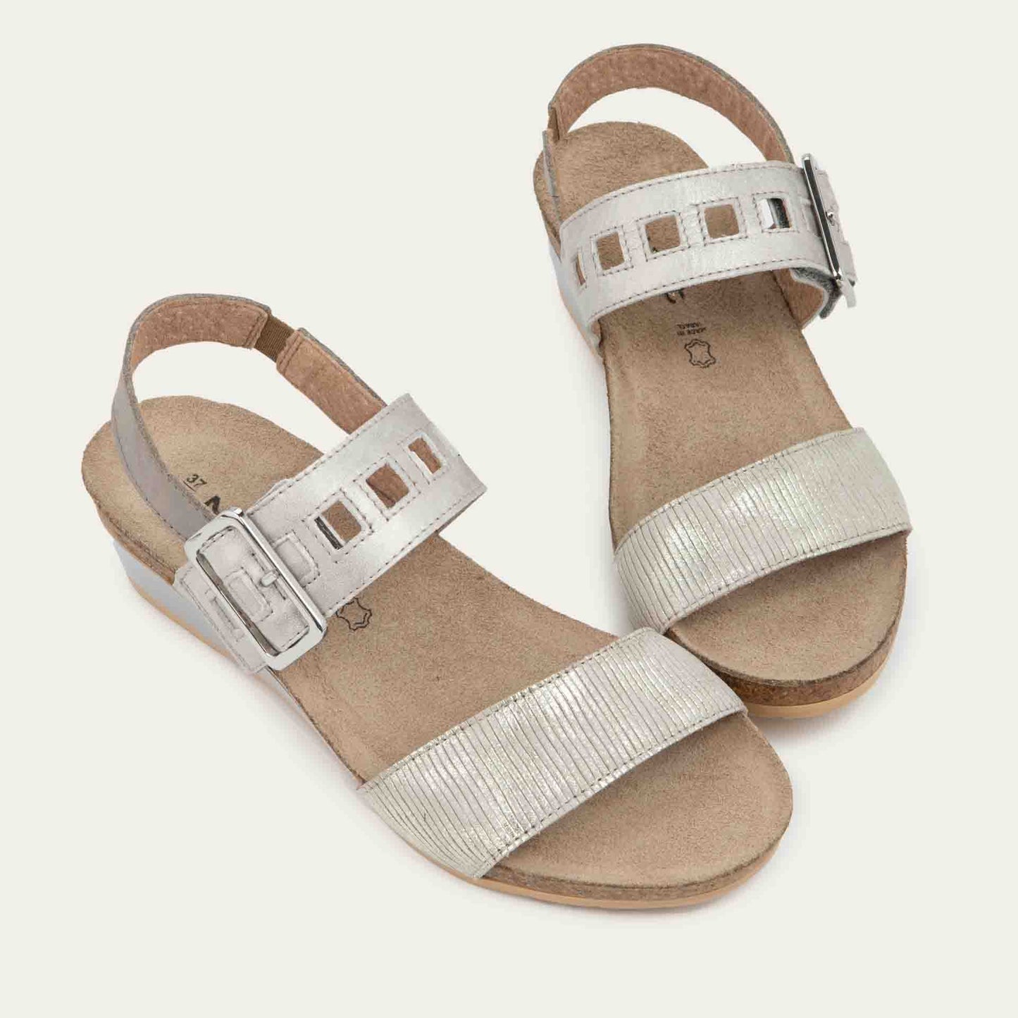 Pair of grey/beige metalic wedge sandals, featuring two straps and a metallic buckle with a cork footbed