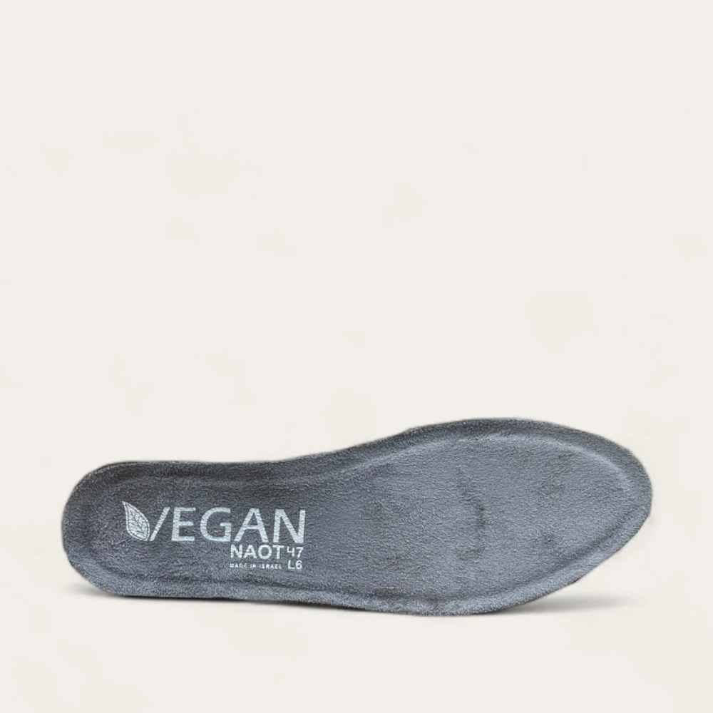 A gray microfiber-covered footbed with the text 'VEGAN' and 'NAOT' on the surface.