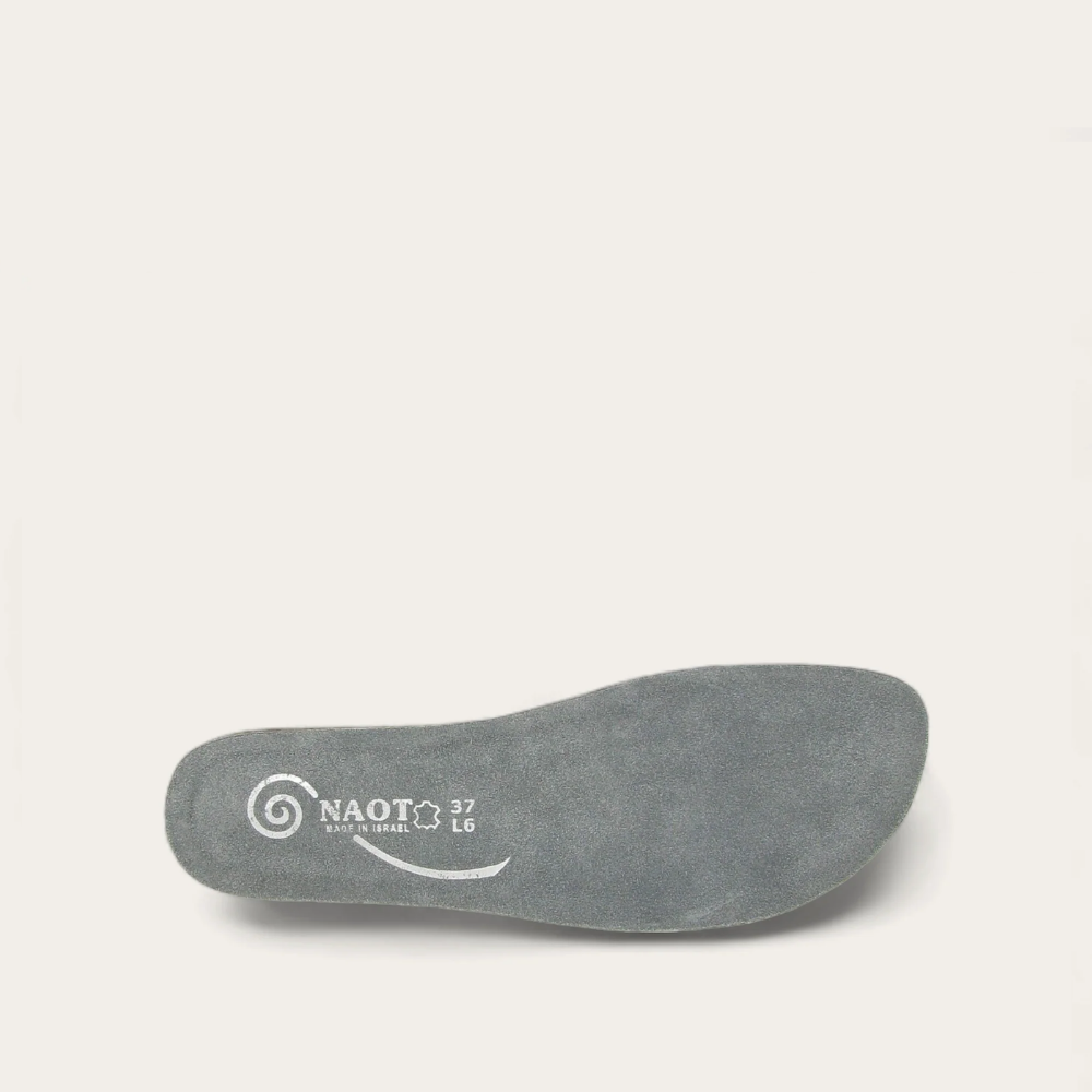 A gray suede footbed with the Naot brand logo on the arch.