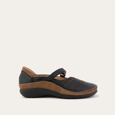Profile view of a brown and black Mary Jane on a textured sole.