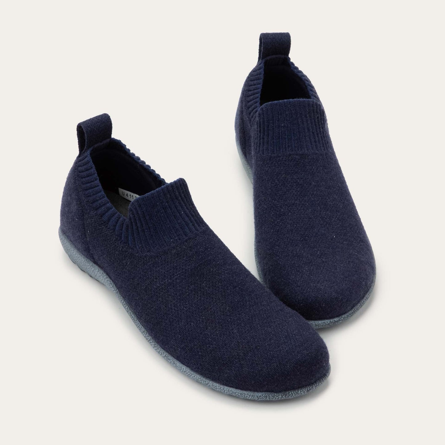 Front view of a pair navy knit slip-on vegan shoes
