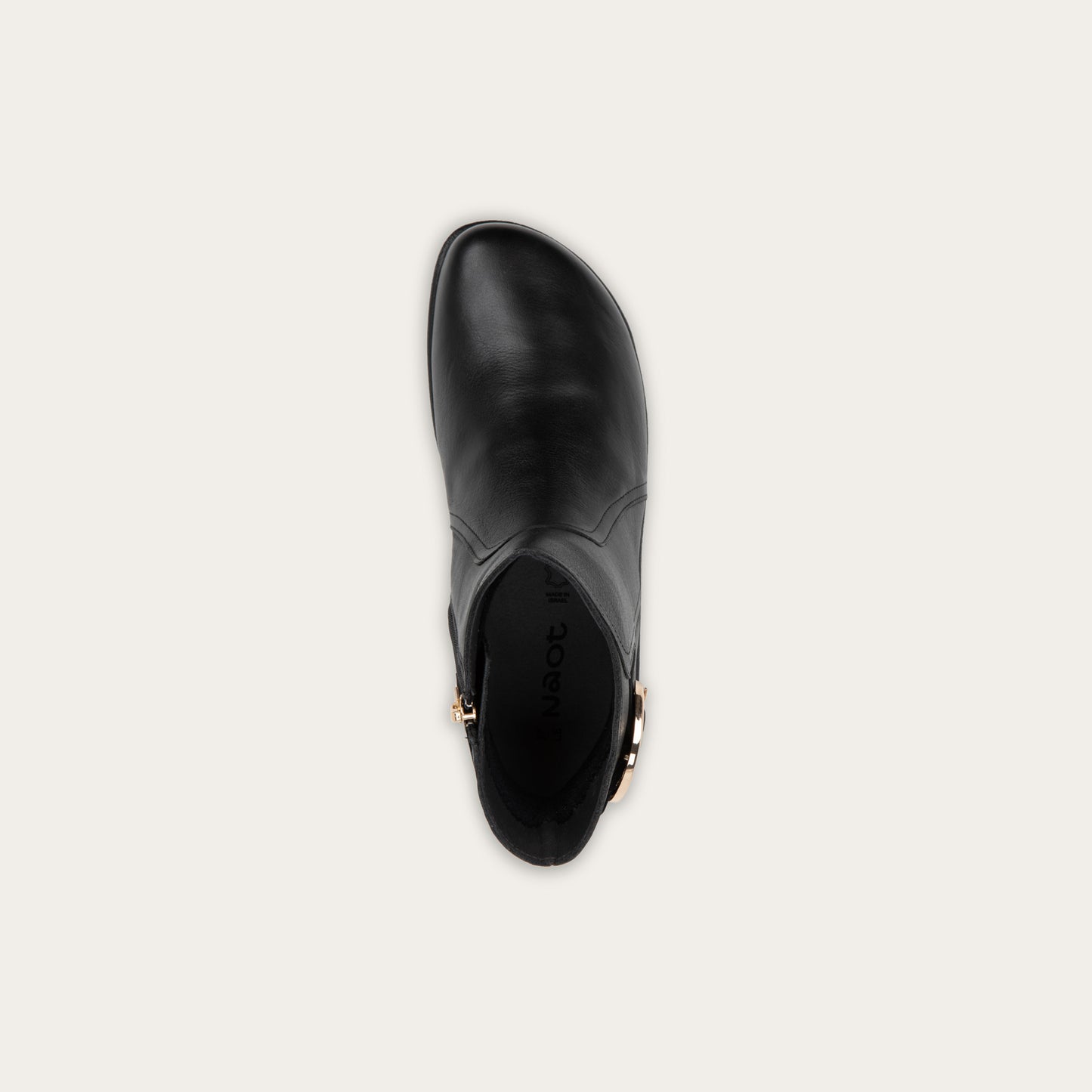 Pair of brown boots featuring an accent strap with round buckle in the back of the shoe on a dark sole.