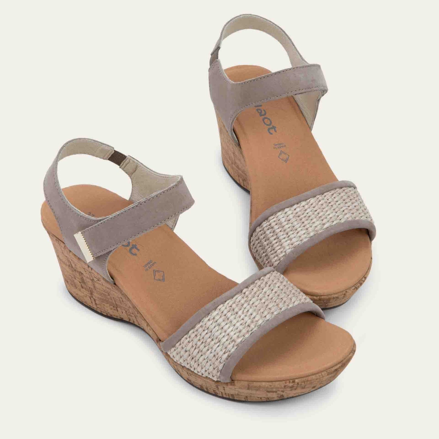 Pair of wedge heeled sandals with a gray leather ankle strap, and woven beige front strap