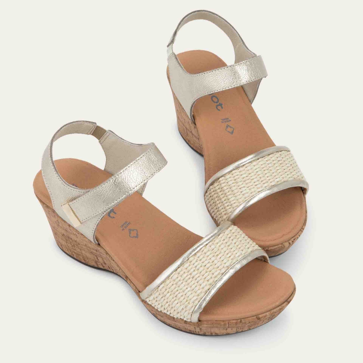 Pair of wedge heeled sandals with a gold leather ankle strap, and woven beige front strap
