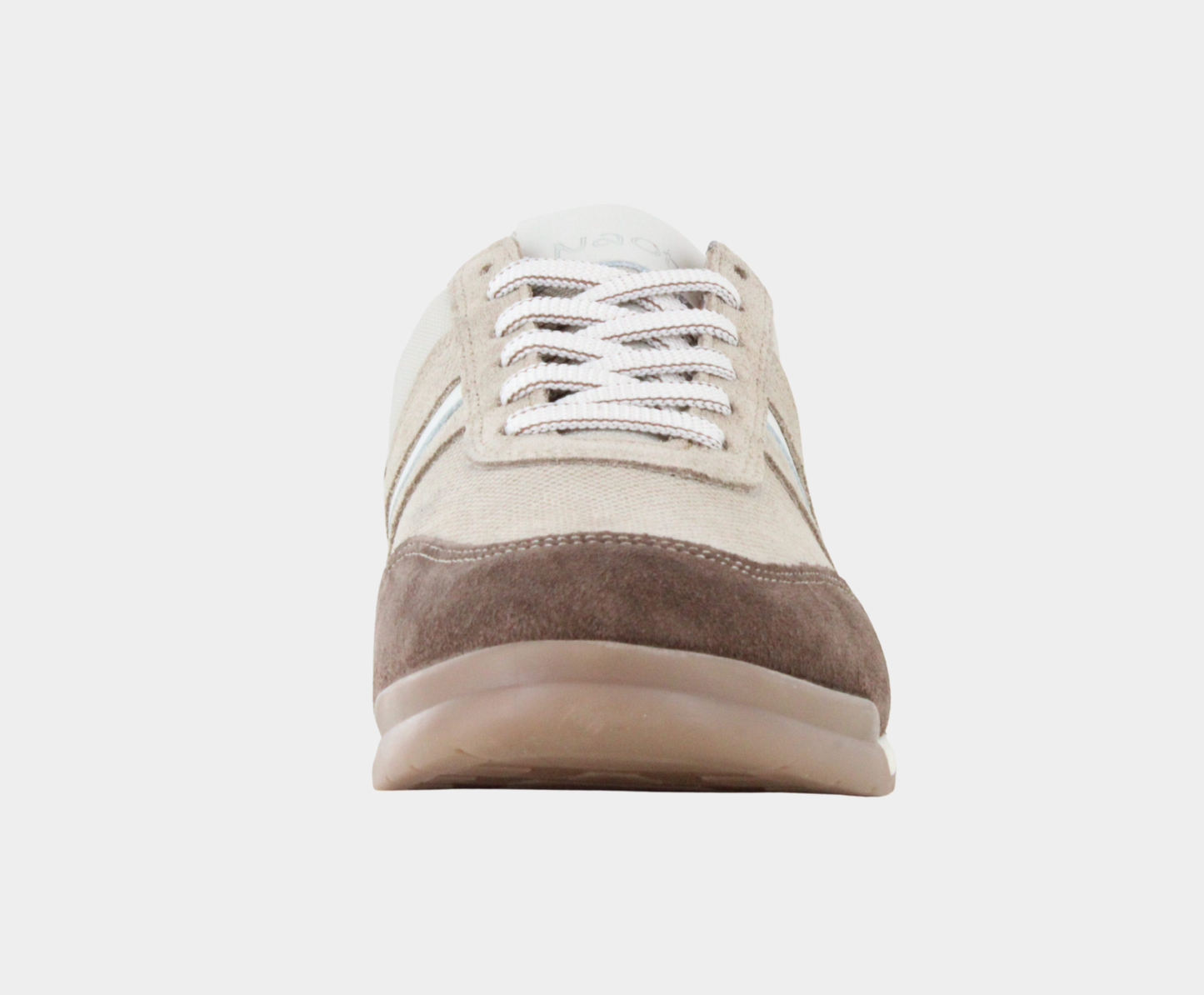 Angled profile view of a low-top sneaker featuring beige canvas, light tan suede overlays, a white side stripe, dark brown suede heel, and a white textured rubber sole.