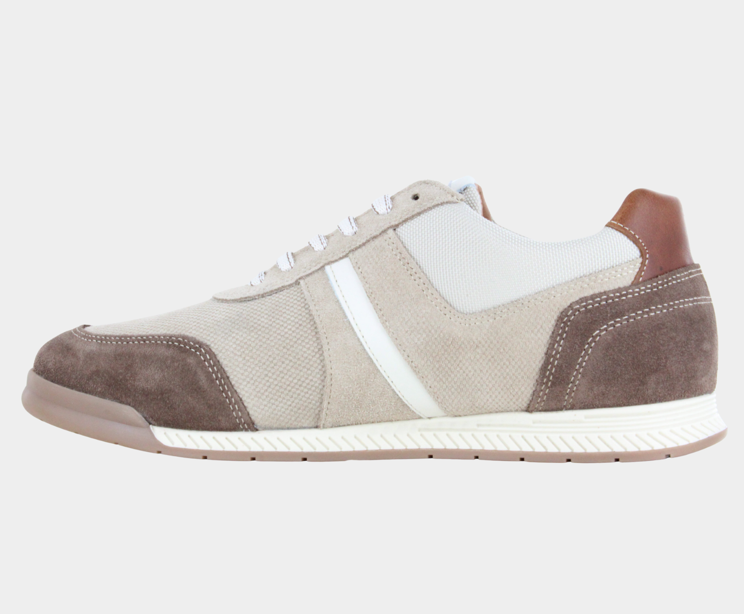 Top view of a low-top sneaker featuring beige canvas, light tan suede overlays, a white side stripe, dark brown suede heel, and a white textured rubber sole.