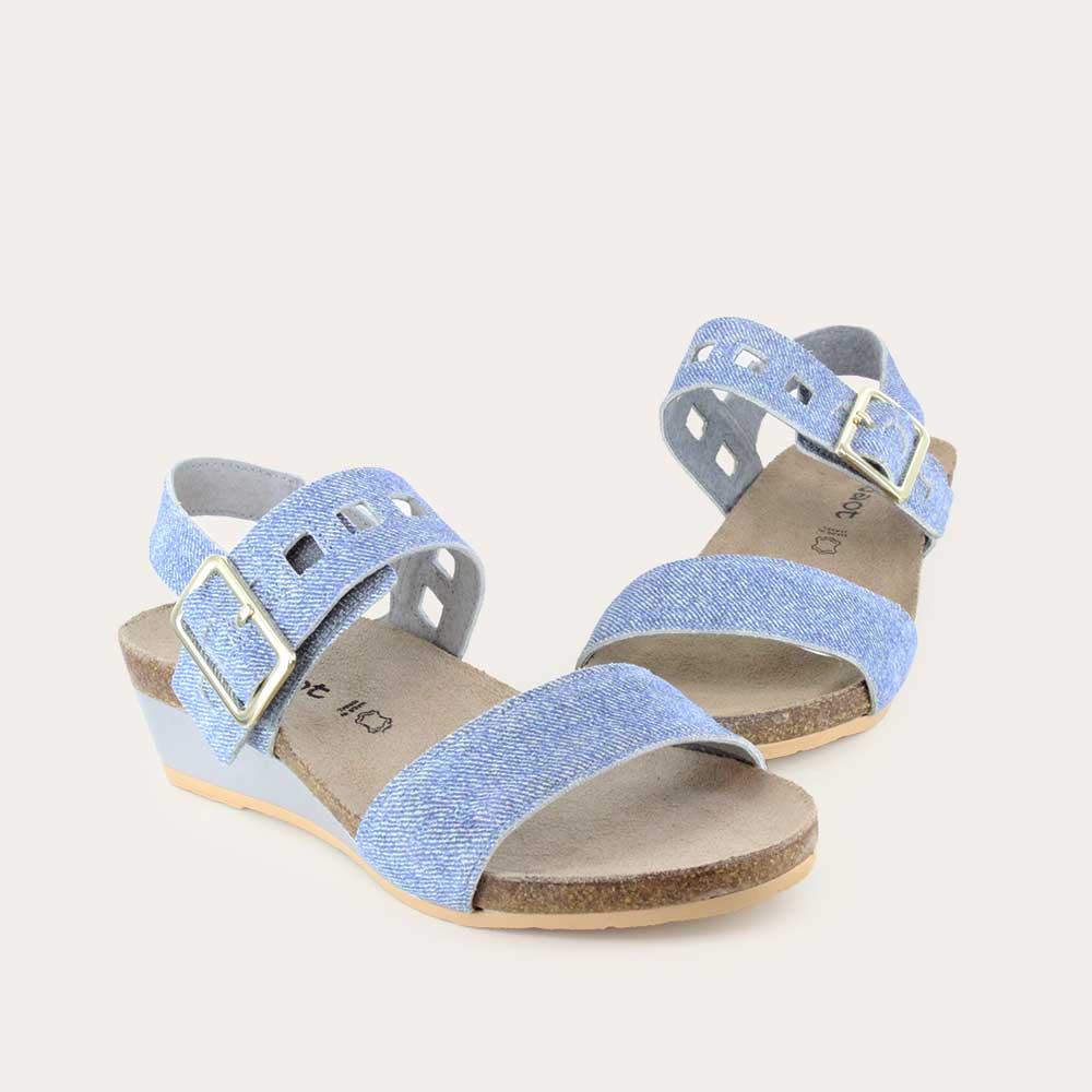 Pair of  blue denim wedge sandals, featuring two straps and a metallic buckle with a cork footbed