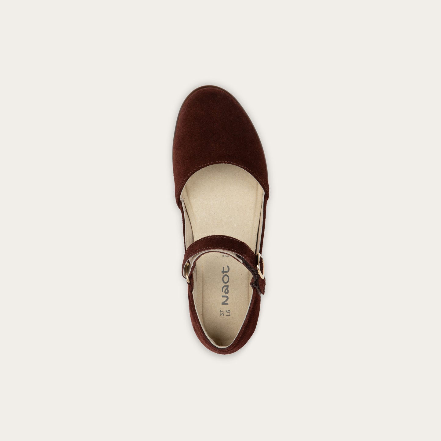 Top view of a red maryjane with a simple buckle strap on a black and brown sole