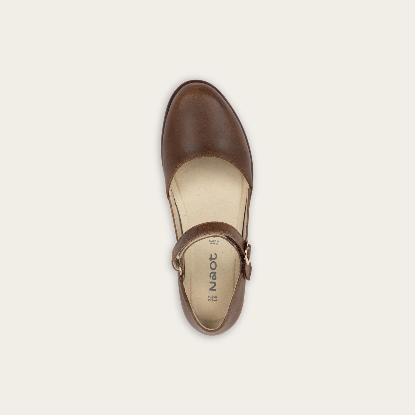 Top view of a brown maryjane with a simple buckle strap on a black and brown sole