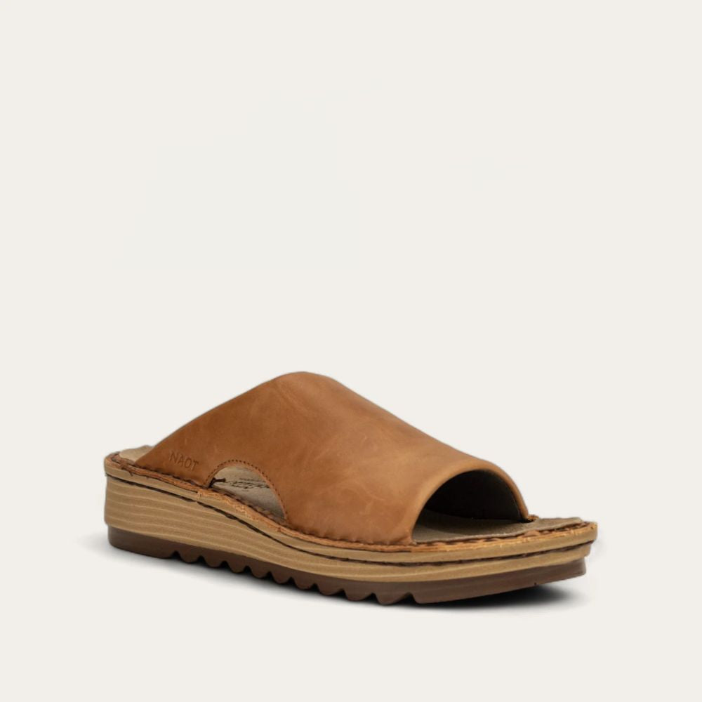 A brown slip-on sandal with a padded upper, cork and latex footbed, and a polyurethane sole.