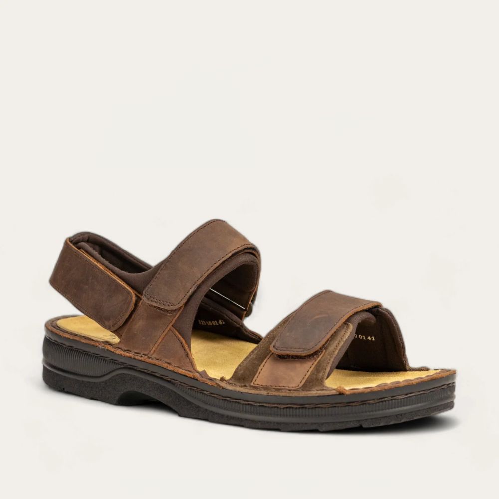 Angled profile view of a brown nubuck sandal featuring 3 hook and loop straps around the foot and ankle for adjustability on a black sole.