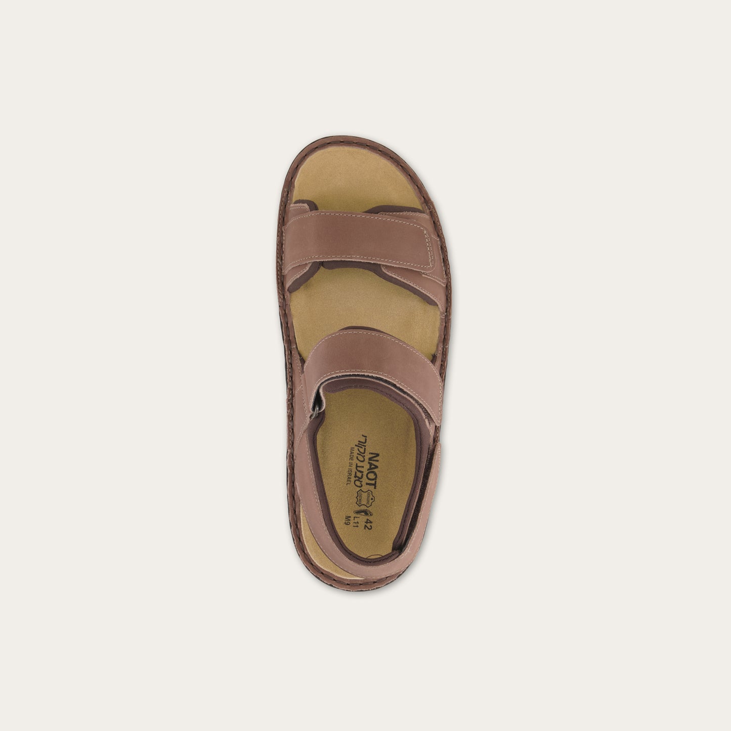 Top view of a brown nubuck sandal featuring 3 hook and loop straps around the foot and ankle for adjustability on a black sole.