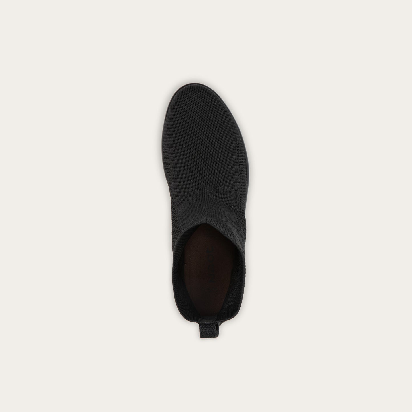 Top view of a black ankle boot featuring a textured knit upper, a pull tab at the heel, and a low, flat black sole.