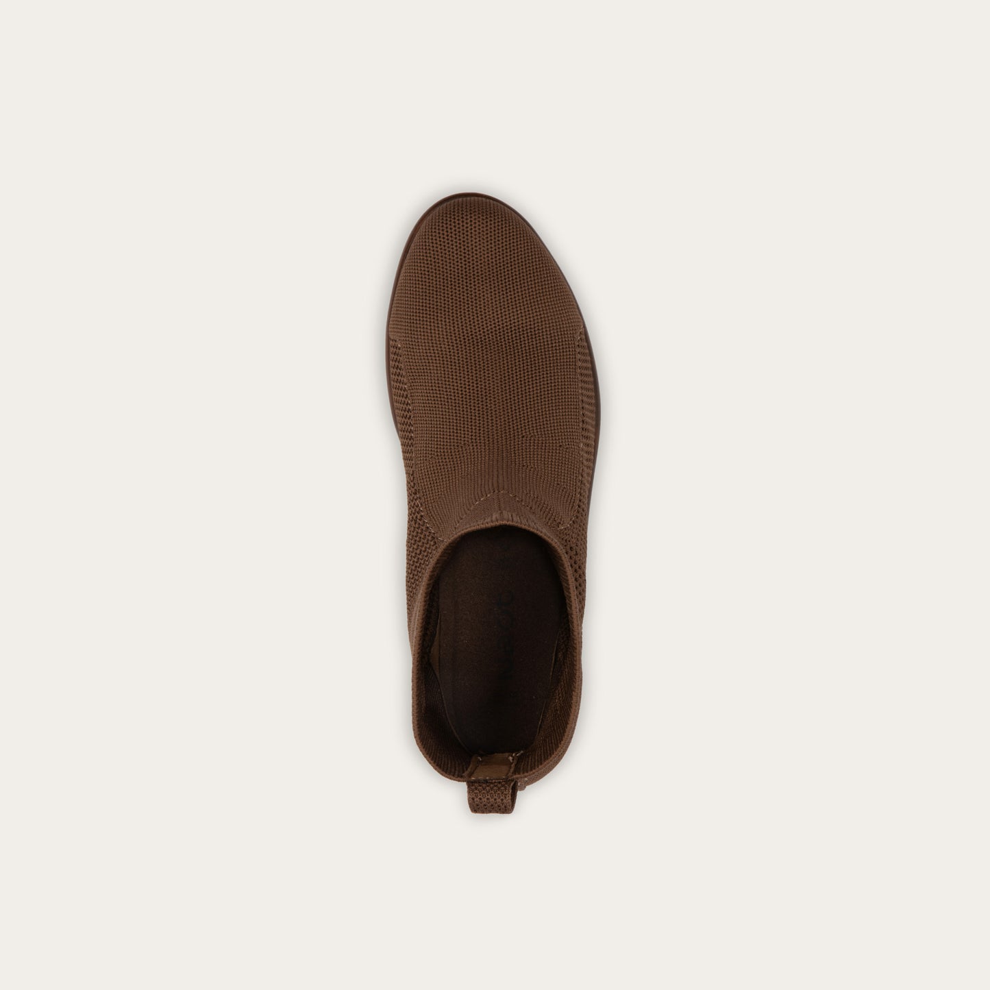 Top view of a brown ankle boot featuring a textured knit upper, a pull tab at the heel, and a low, flat brown sole.