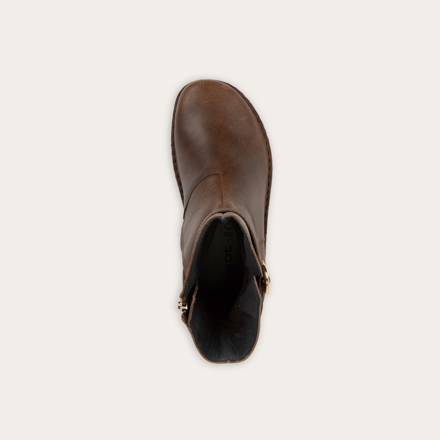 Top view of a brown calf boot with a simple strap and buckle detail