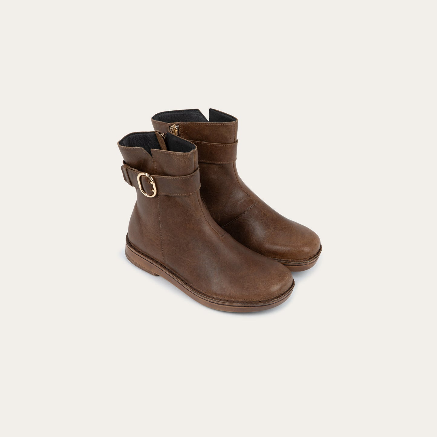 Pair of  brown calf boots with a simple strap and buckle detail
