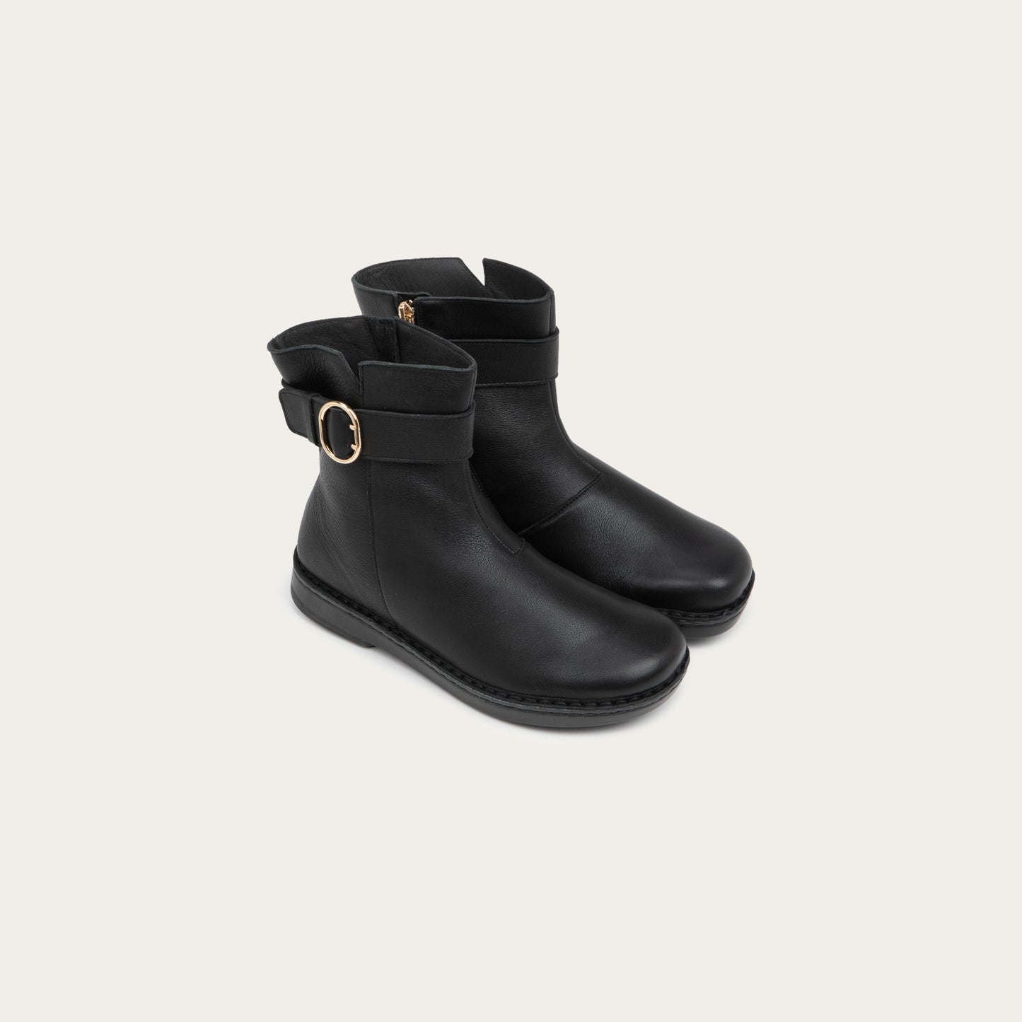 Pair of  black calf boots with a simple strap and buckle detail