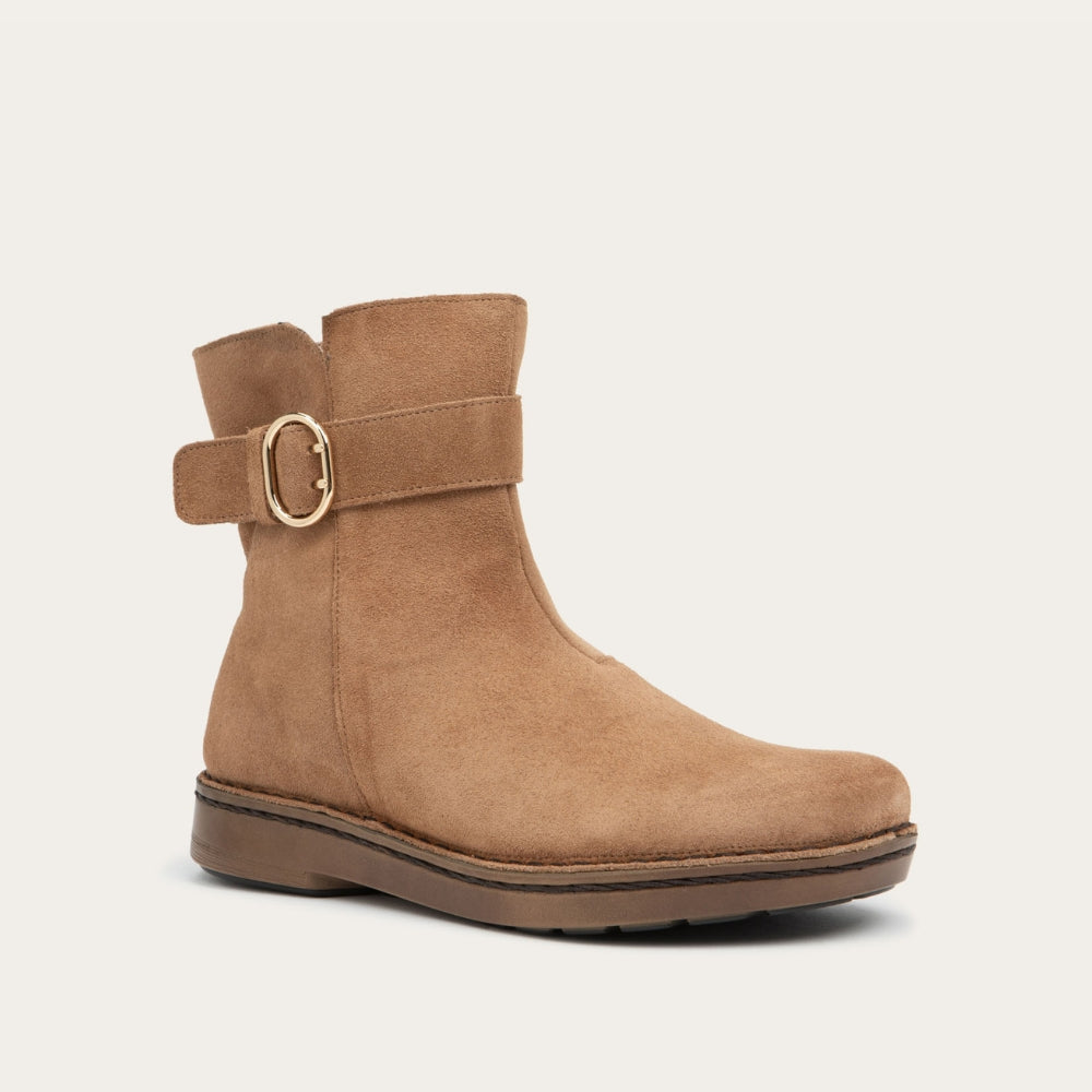 Angled view of a tan calf boot with a simple strap and buckle detail