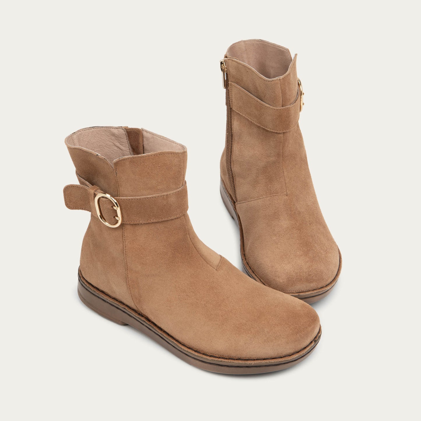 Pair of  tan calf boots with a simple strap and buckle detail