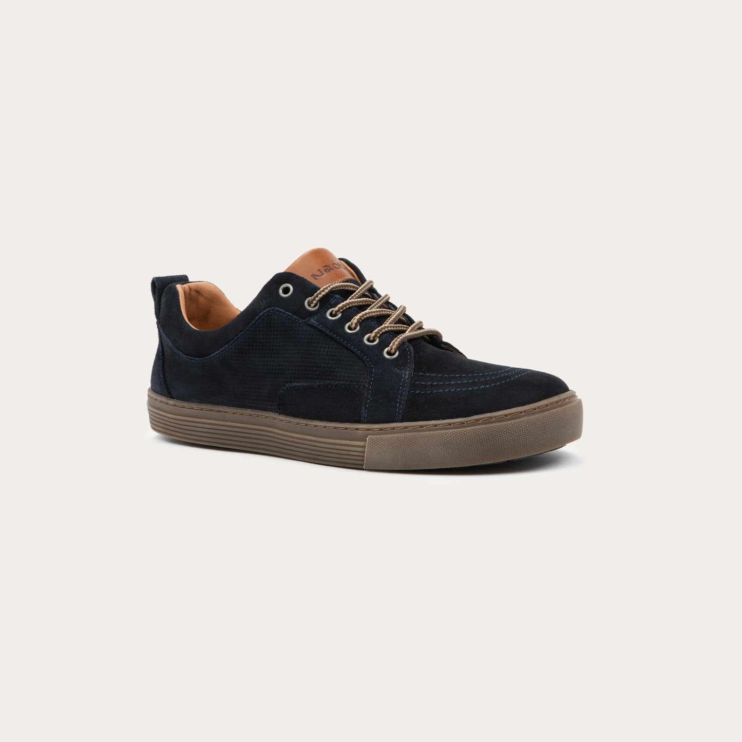 Angled profile view of a black low-top sneaker with tan laces, a brown sole, and tan interior lining, 