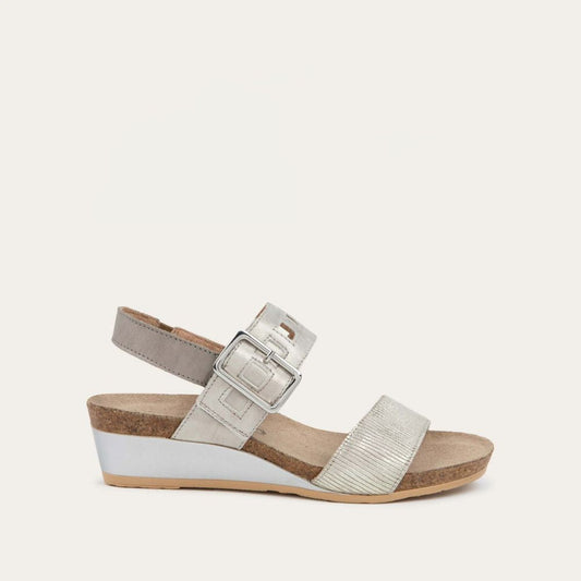 Profile view of a grey/beige metalic wedge sandal, featuring two straps and a metallic buckle with a cork footbed.