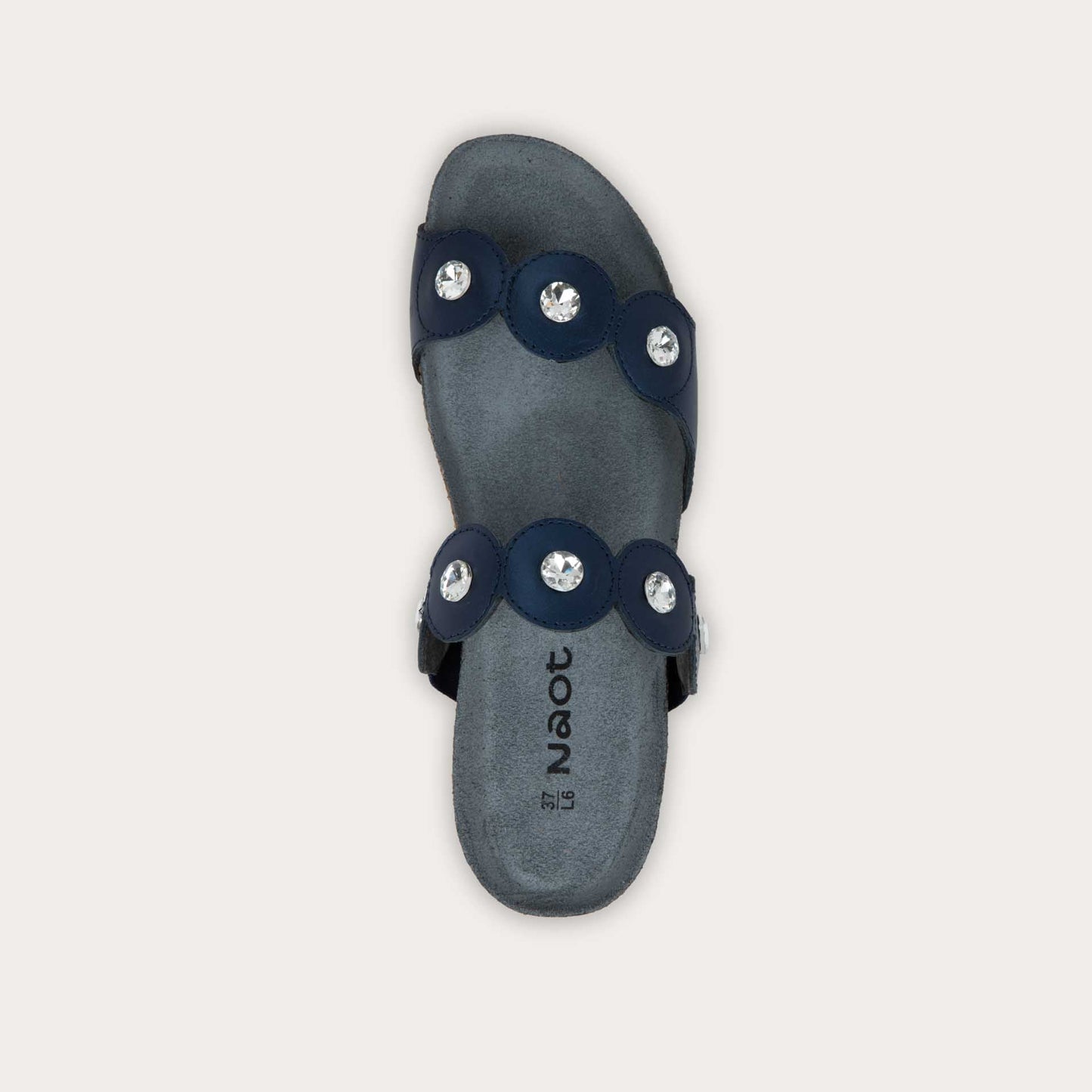Top view of navy blue sandal with cork wedge sole. Features two straps with circular details and large round silver studs.