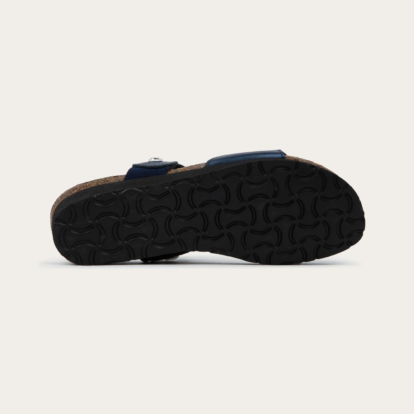 Bottom view of navy blue sandal with cork wedge sole. Features two straps with circular details and large round silver studs.