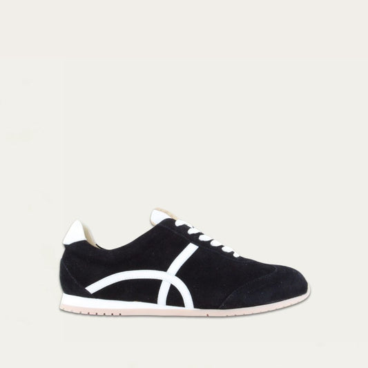 Profile view of a black suede sneaker with a swirl accent on the side on a low white and beige sole. 