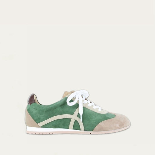 Profile view of a green suede sneaker with a swirl accent on the side on a low white and beige sole. 