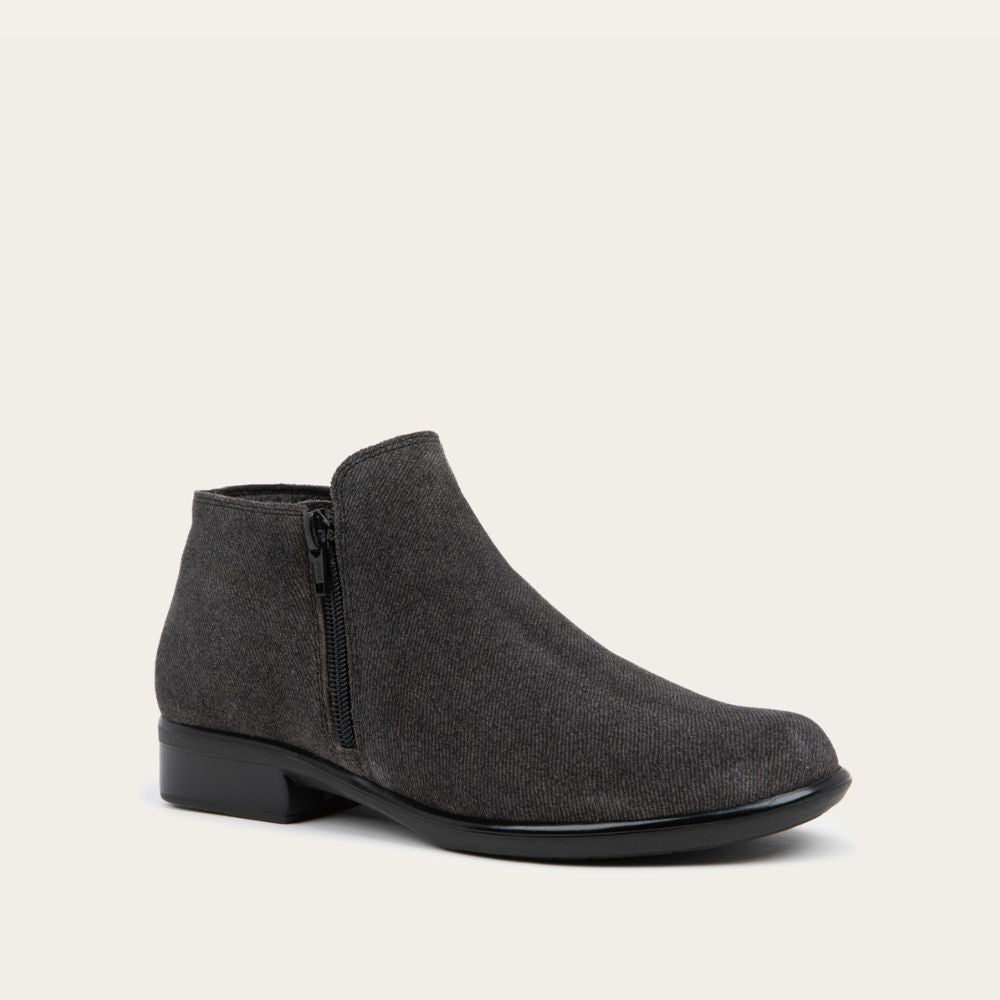 Angled side view of a black suede bootie on a black and brown sole.