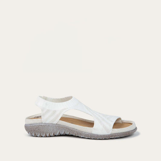 Profile view of a white sparkle knit cutout sandal with open toes, elastic ankle strap, and black textured sole.
