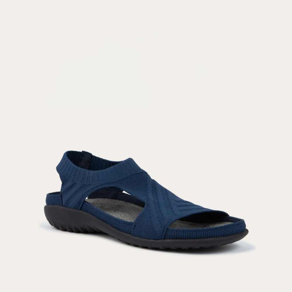 Angled profile view of a navy knit cutout sandal with open toes, elastic ankle strap, and black textured sole.