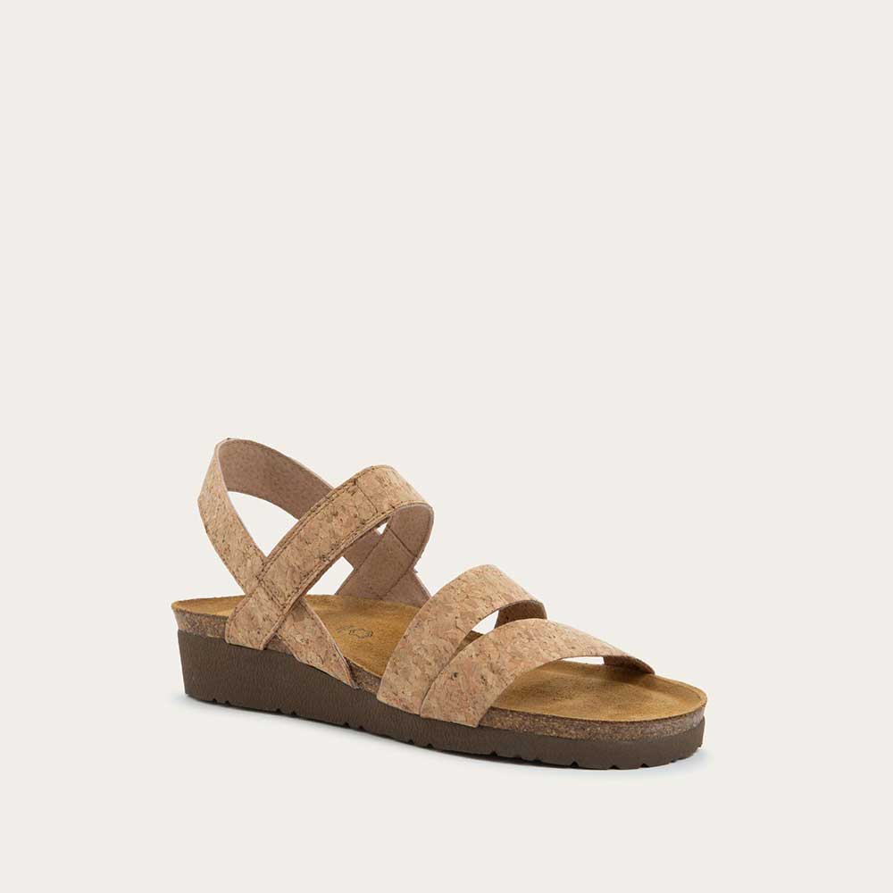 Angled profile view of cork-leather sandal with a cork footbed, black sole, and triple-strap design including a crisscross ankle strap.