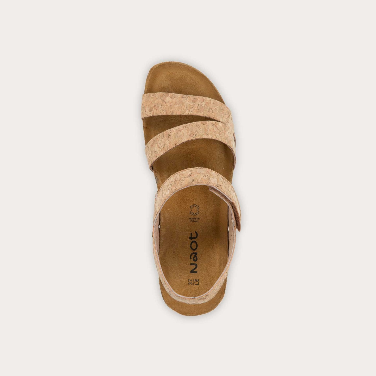 Top view of cork-leather sandal with a cork footbed, black sole, and triple-strap design including a crisscross ankle strap.