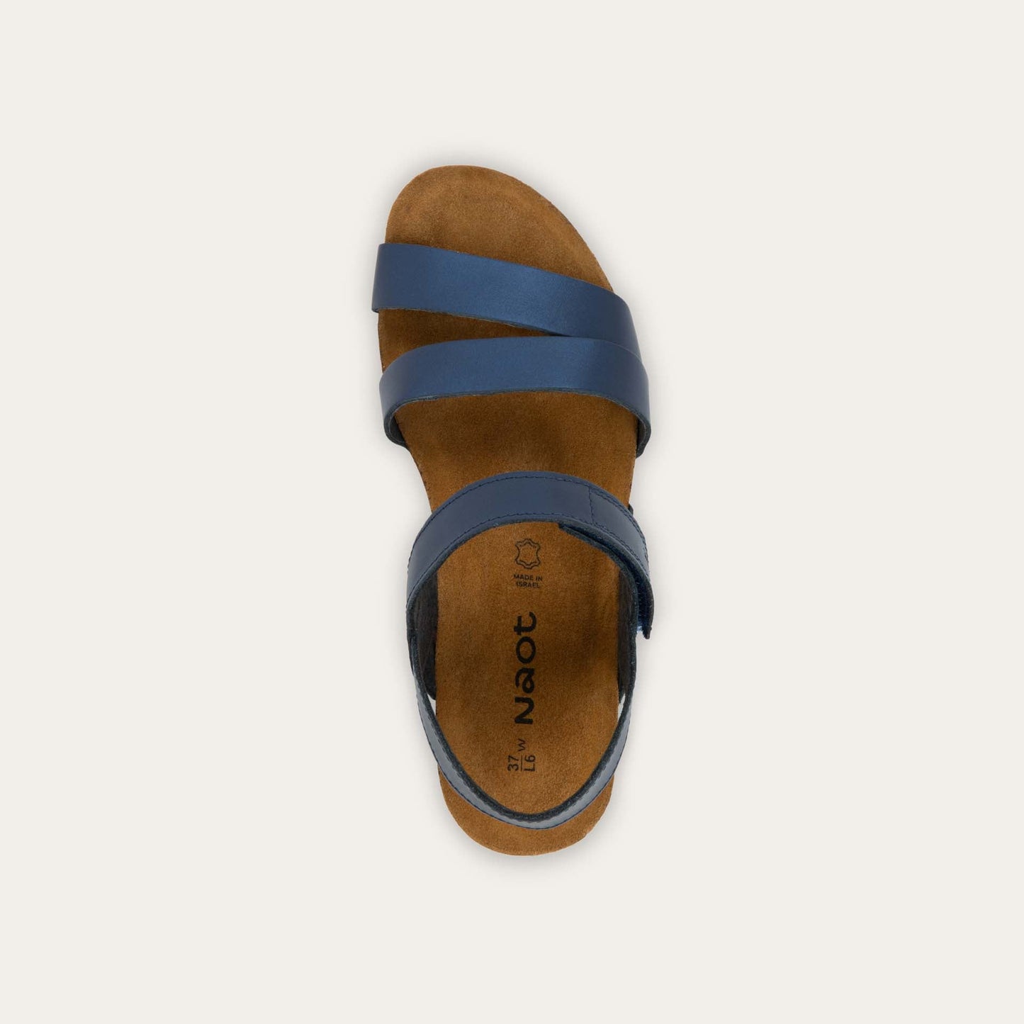 Top view of a navy blue sandal with a cork footbed, black sole, and triple-strap design including a crisscross ankle strap.