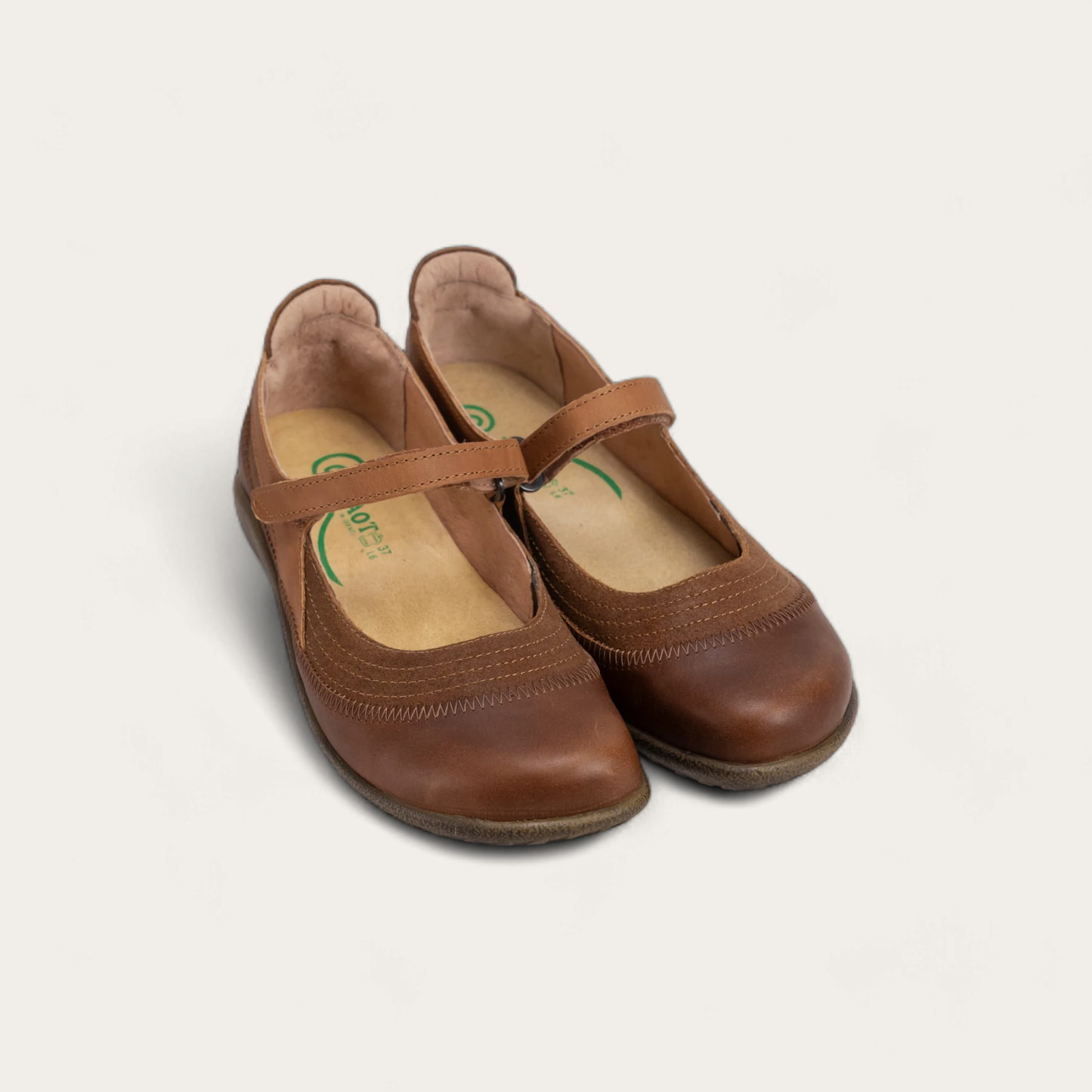 Pair of brown leather Mary Jane shoes with a hook-and-loop strap