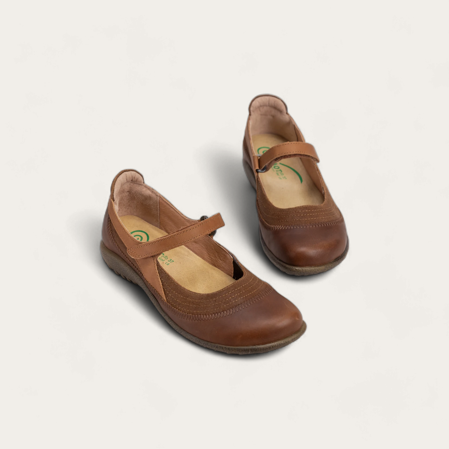 Pair of brown leather Mary Jane shoes with a hook-and-loop strap