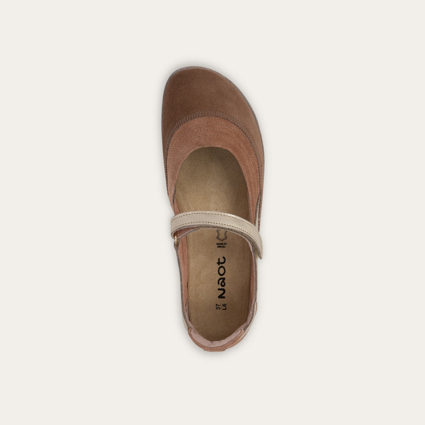 Top view of a brown Mary Jane flat with metallic strap, suede upper and textured sole.