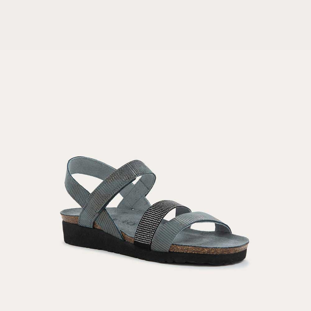 Angled profile view of a gray sandal with two textured straps and a studded strap on a cork and black rubber sole,