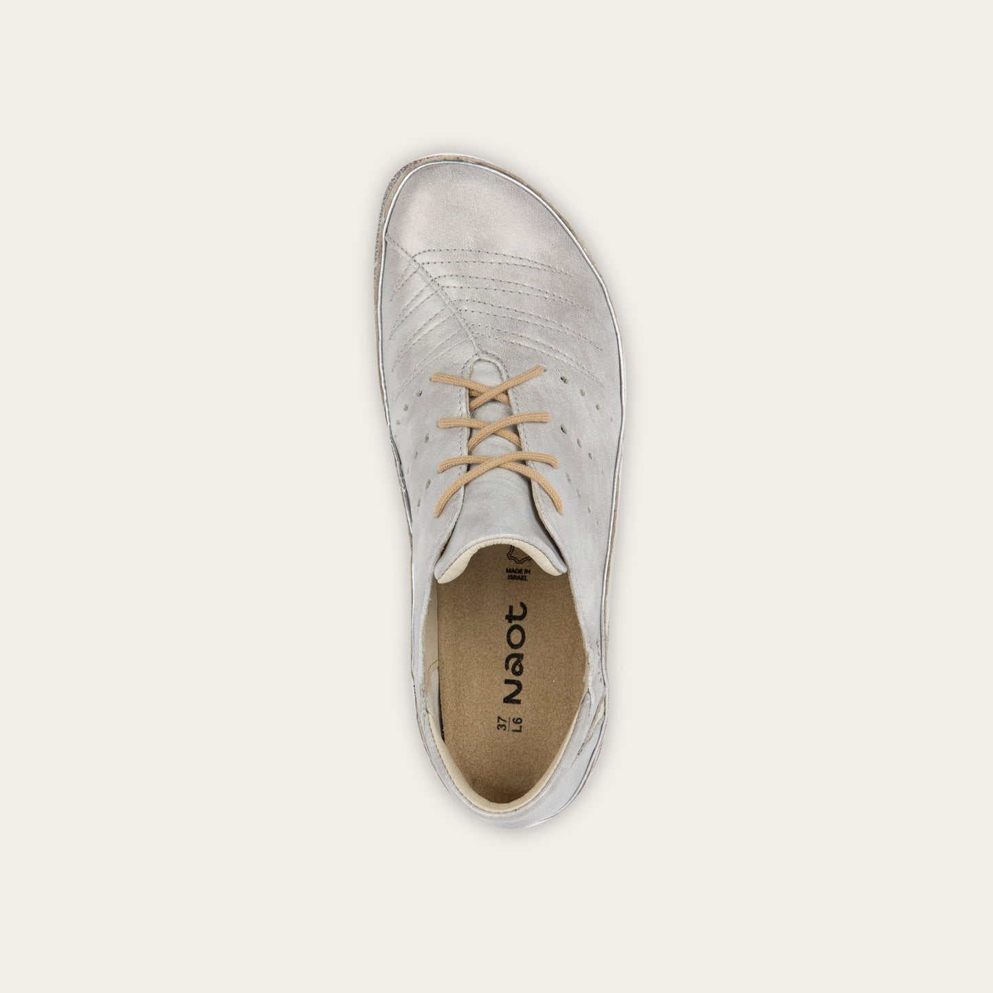 Top view of a casual beige lace-up shoe with textured sole and  side perforations.
