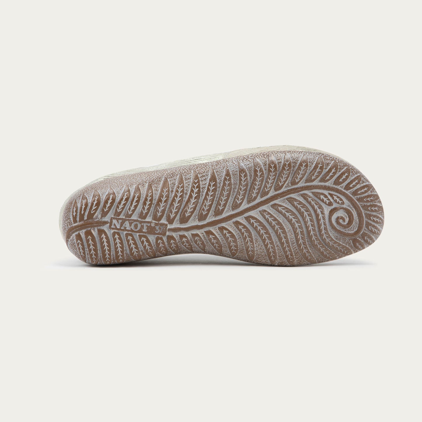 Bottom view of a casual beige lace-up shoe with textured sole and side perforations.