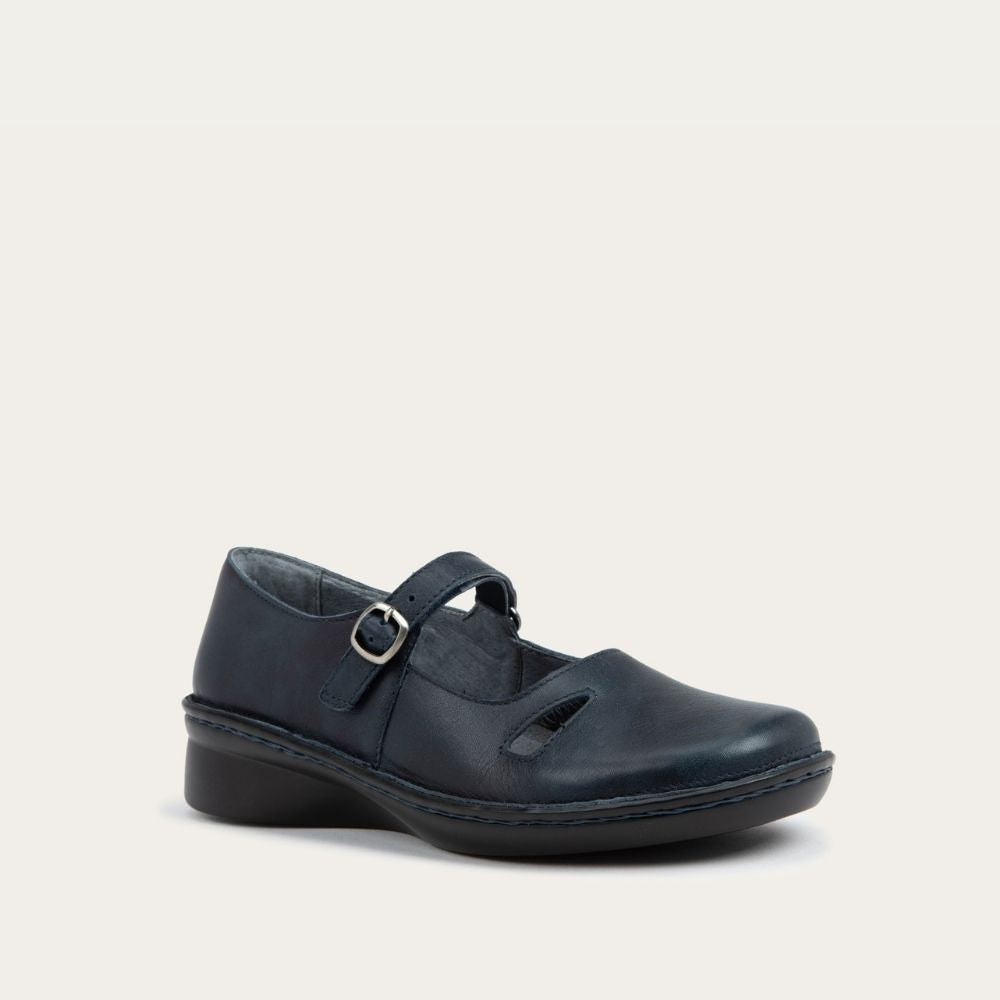 Angled profile view of a black maryjane on a black sole featuring a simple buckle and small cutout detail on the side