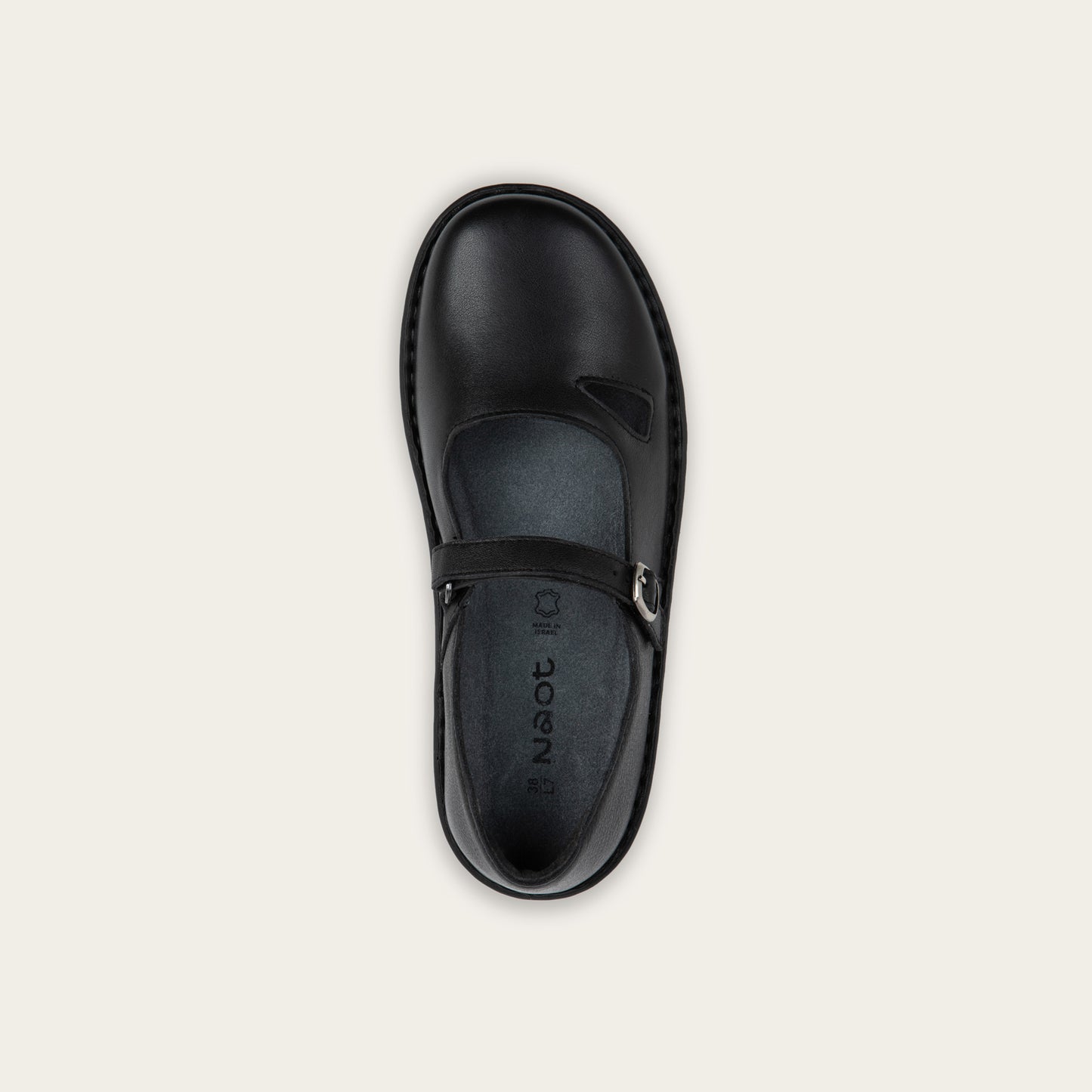 Top view of a black maryjane on a black sole featuring a simple buckle and small cutout detail on the side