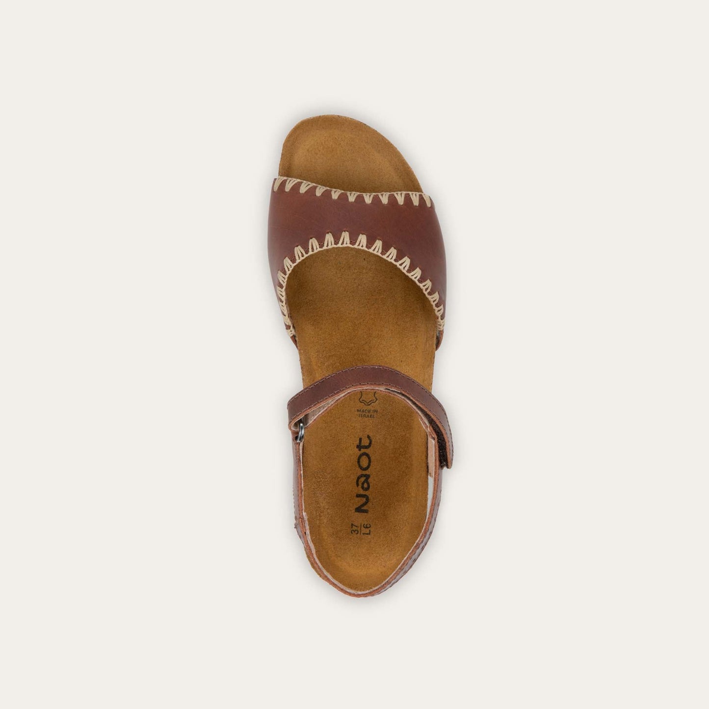 Top view of a brown sandal featuring a toe strap with contrast stitiching, adjustable ankle strap, and a cork footbed.