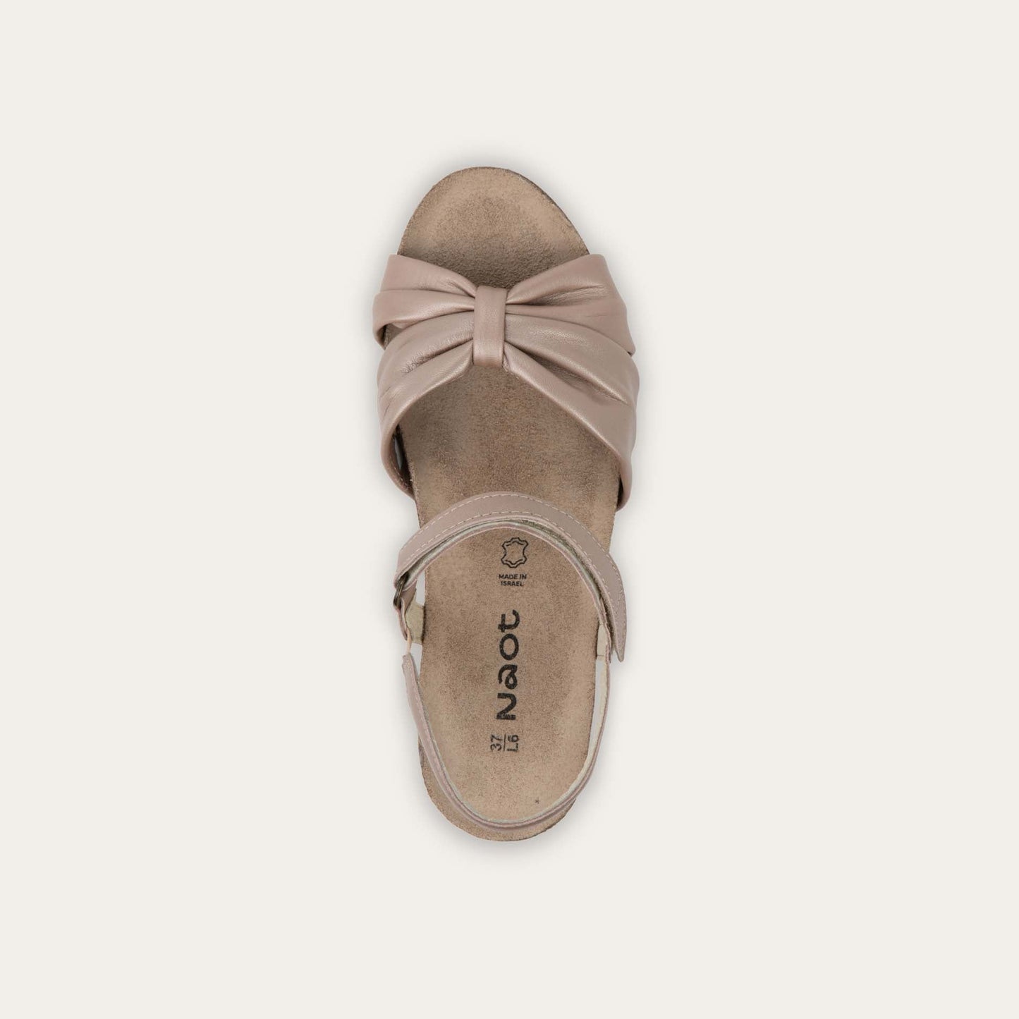 Top view of a mauve wedge sandal with an ankle strap and twisted front strap, featuring a cork footbed and wedge heel. 