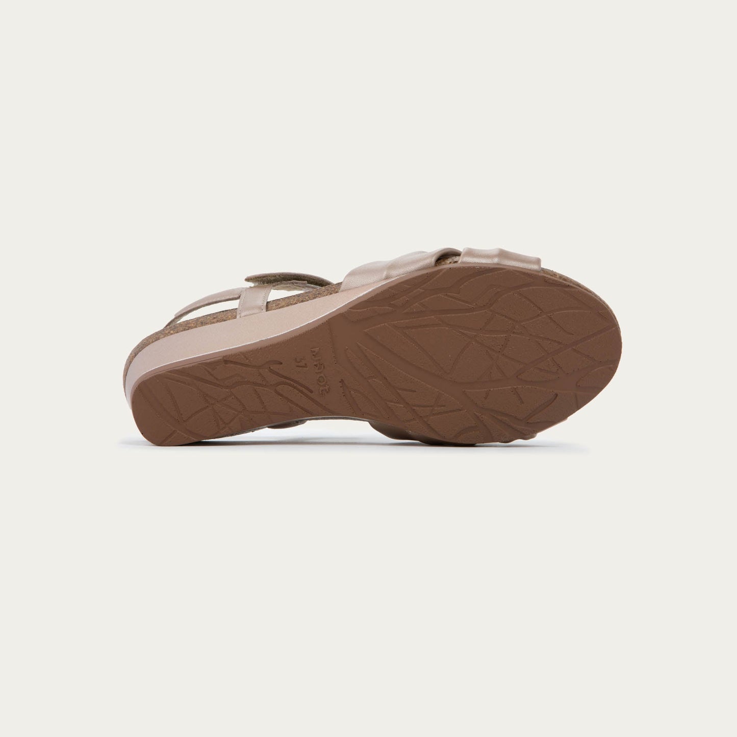 Bottom view of a mauve wedge sandal with an ankle strap and twisted front strap, featuring a cork footbed and wedge heel. 