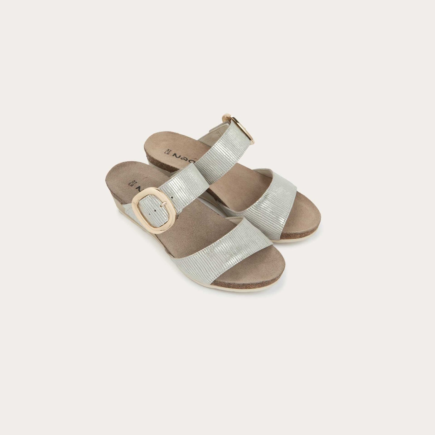 Pair of metallic gray textured wedge sandals with two straps and a large gold buckle. 