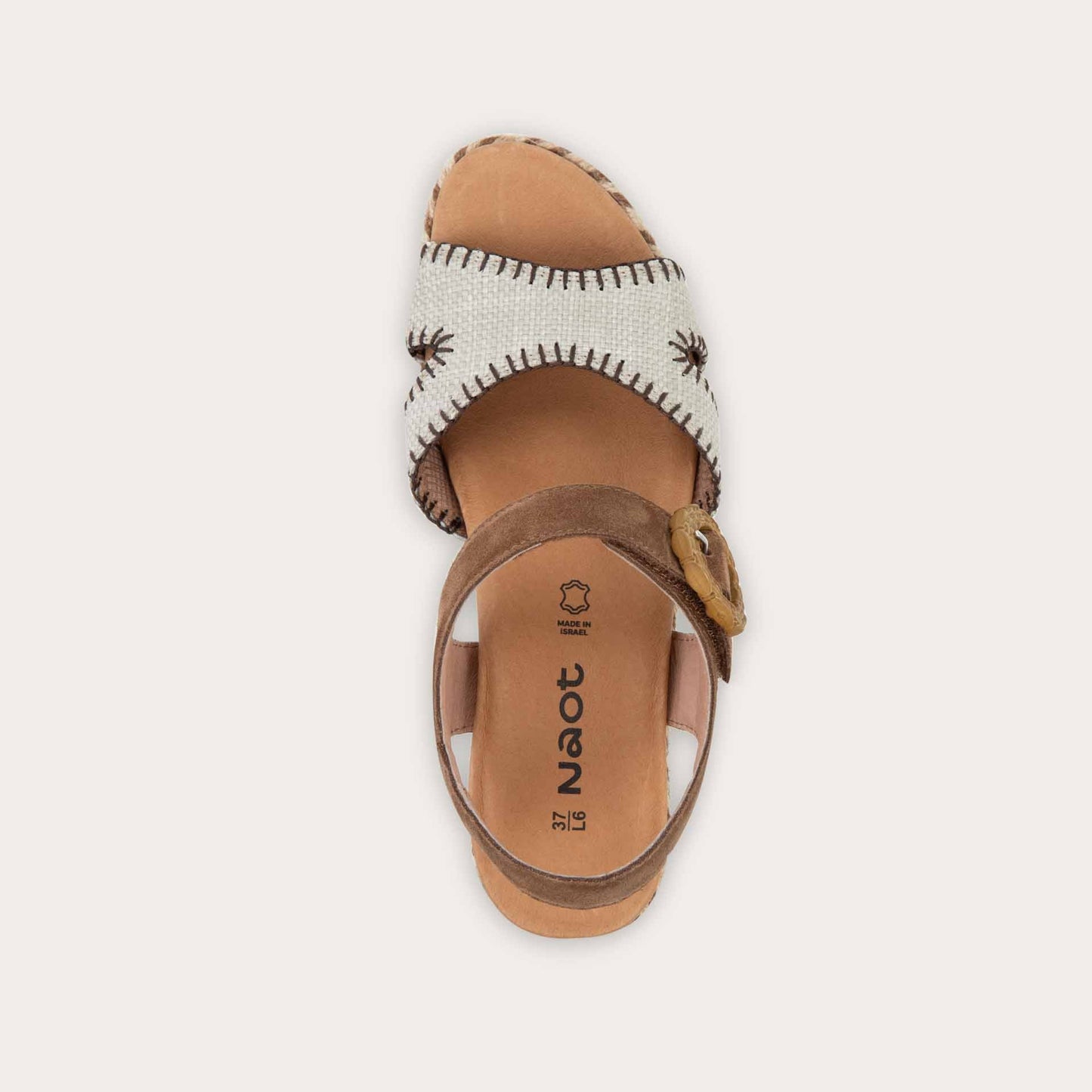 Top view of a beige/brown wedge sandal with a woven platform and brown suede ankle strap, fastened by a circular buckle. 