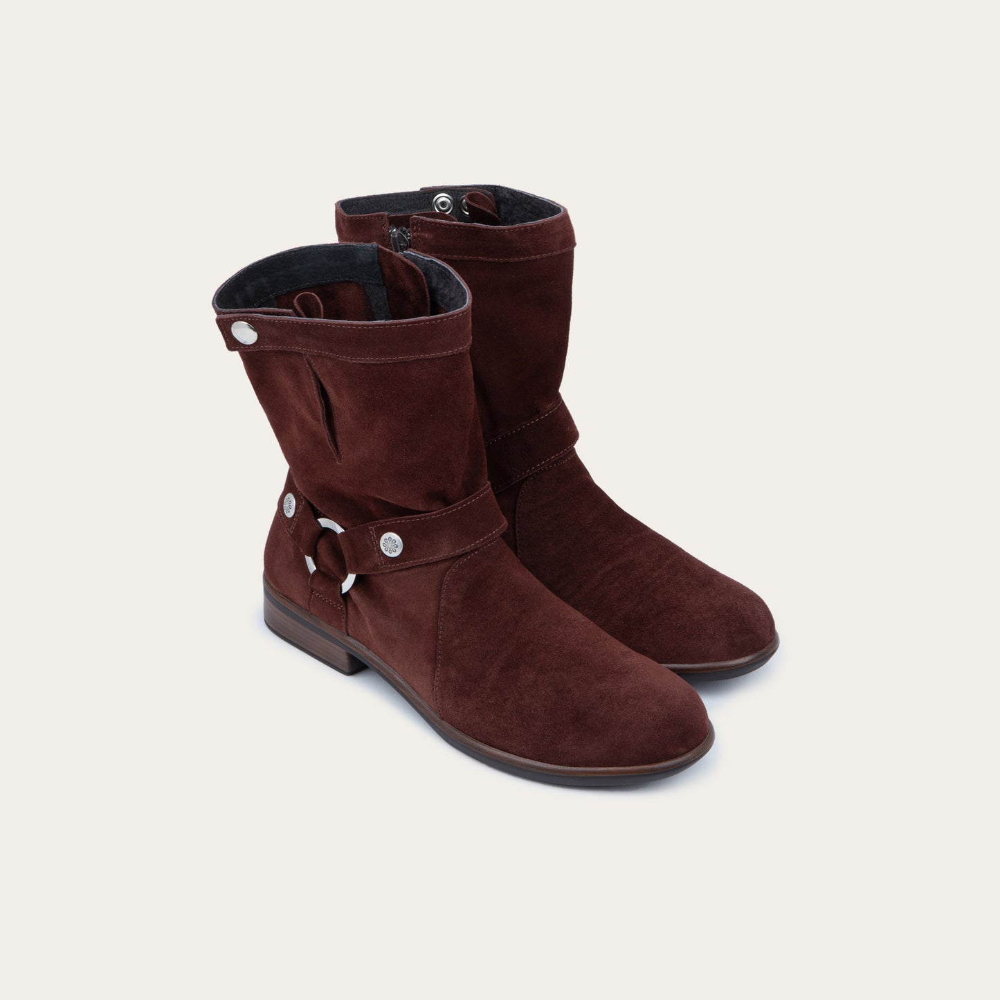 Pair of violet suede mid-calf boots with decorative t-strap and buckle, side zipper, rounded toe, and low stacked heel
