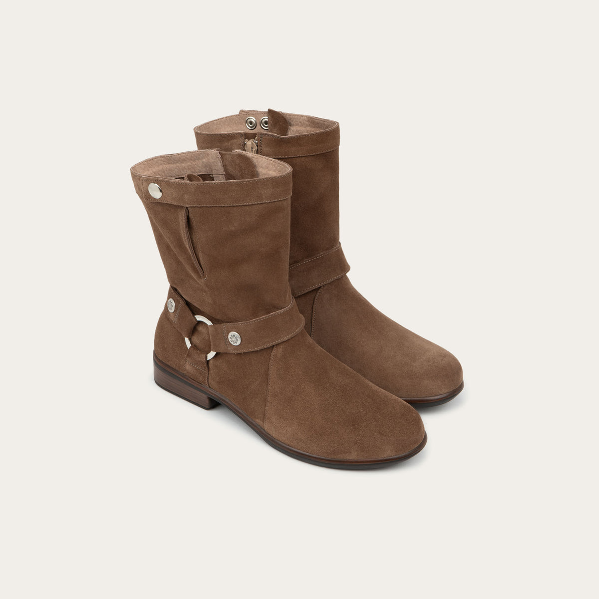 Pair of brown suede mid-calf boots with decorative t-strap and buckle, side zipper, rounded toe, and low stacked heel
